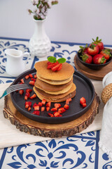 Stack of pancakes hotcakes with honey and strawberries breakfast food american style