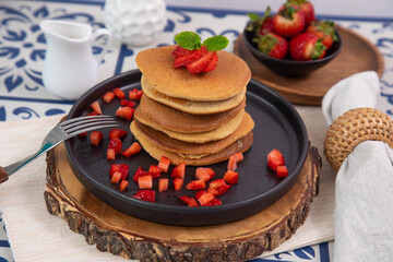 Stack of pancakes hotcakes with honey and strawberries breakfast food american style