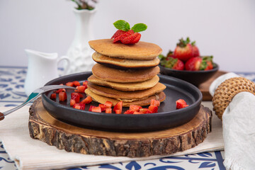 Stack of pancakes hotcakes with honey and strawberries breakfast food american style