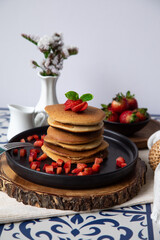 Stack of pancakes hotcakes with honey and strawberries breakfast food american style