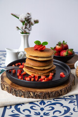 Stack of pancakes hotcakes with honey and strawberries breakfast food american style
