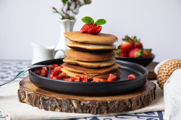 Stack of pancakes hotcakes with honey and strawberries breakfast food american style