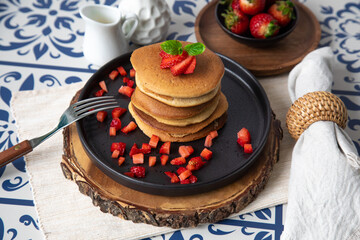 Stack of pancakes hotcakes with honey and strawberries breakfast food american style