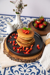 Stack of pancakes hotcakes with honey and strawberries breakfast food american style