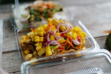 spicy corn salad in plastic food box