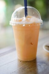 Yogurt smoothie with oranges on a wooden table