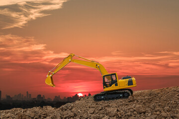 Crawler excavator with are digging the soil in the construction site on the sunset  backgrounds