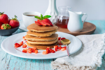 Stack of pancakes hotcakes with honey and strawberries breakfast food american style