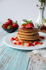 Stack of pancakes hotcakes with honey and strawberries breakfast food american style