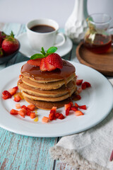 Stack of pancakes hotcakes with honey and strawberries breakfast food american style
