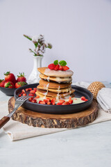 Stack of pancakes hotcakes with honey and strawberries breakfast food american style