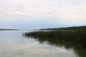 calm lake waters under white clouds