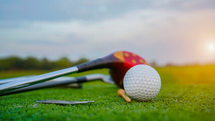 Top view of golf equipment on green grass at golf course.