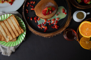 Stack of pancakes hotcakes with honey and strawberries breakfast food american style