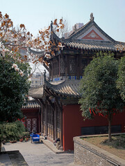A chinese traditional building surrounded by trees in a Taoism temple 