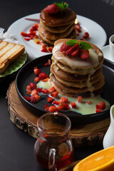 Stack of pancakes hotcakes with honey and strawberries breakfast food american style