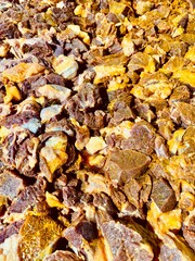 Close-up of raw beef pieces seasoned with vibrant turmeric powder, ready for cooking. The rich yellow spice contrasts beautifully with the fresh meat, highlighting a traditional culinary preparation p