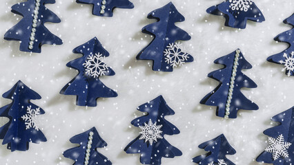 Winter Holidays decor, Christmas trees from blue craft paper and snow, Christmas New Year trend...