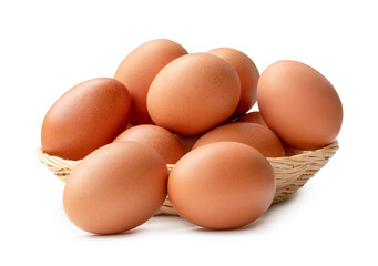 Side view of brown chicken eggs in stack in wicker basket isolated on white background