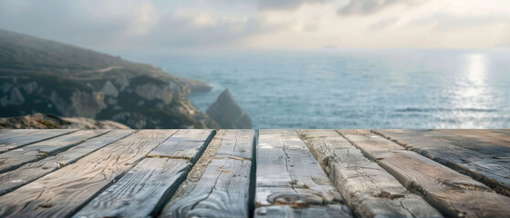 front view of empty raw wooden plank old table with blurred horizon ocean beach and cloudy blue sky background