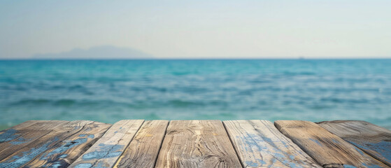 front view of empty raw wooden plank old table with blurred horizon ocean beach and cloudy blue sky background