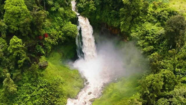 Waterfall in the jungle in slow motion. Telun Berasap Falls in the rainforest. Sumatra, Jambi, Indonesia.