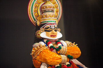Kathakali dancer in yellow facial makeup depicting subhramanya god