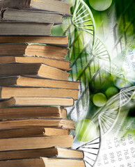 stack of books and stylized DNA models on a green blurred background