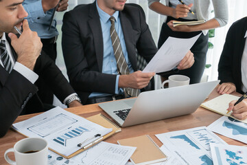 Diverse group of business analyst team analyzing financial data report paper on office table. Chart...