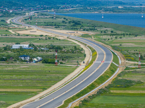 Romania A1 highway construction site. Aerial view of A1 road that connects Bucharest Pitesti highway with Curtea de Arges and Sibiu. Infrastructure construction industry in Romania.