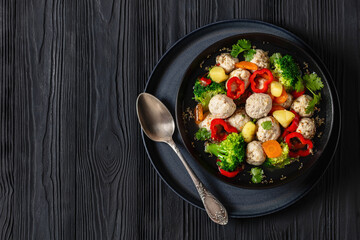 chicken meatball soup with vegetables in a bowl