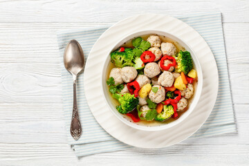 chicken meatball soup with vegetables in a bowl