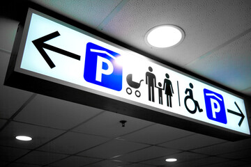 Obraz premium Indoor parking location sign with infants-priority (parents carrying their children) and disability parking spot.