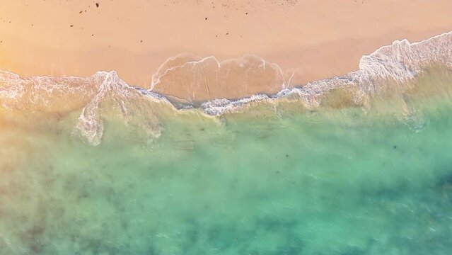 4K UHD aerial drone view top view waves crashing empty beach from above. Areal drone view. 