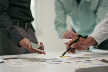 Business meeting with professionals discussing charts and graphs on a table, team collaboration and...