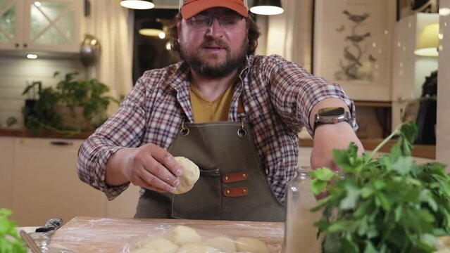 a male chef makes kutab dough in a home kitchen