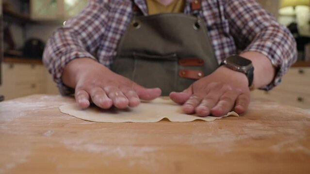 a male chef makes kutab dough in a home kitchen