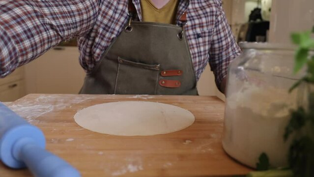 a male chef makes kutab dough in a home kitchen