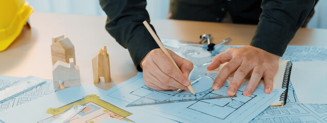 Professional engineer measuring the blueprint. Professional engineer working architectural project...