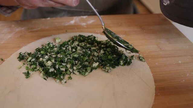 a male chef makes kutab dough in a home kitchen