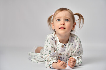 Portrait of cute little girl with blue eyes on a white background with copy space