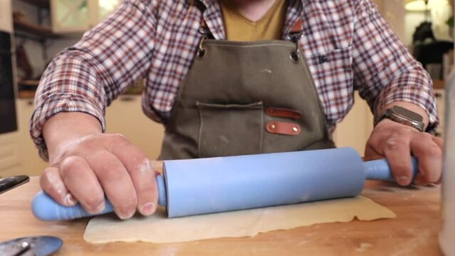 a male chef makes kutab dough in a home kitchen