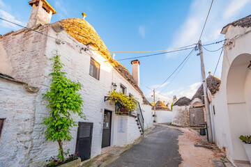 Trulli of Alberobello, Puglia, Italy. town of Alberobello with trulli houses among green plants and...