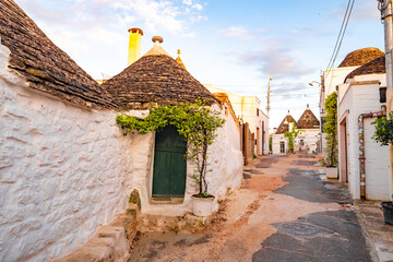 Trulli of Alberobello, Puglia, Italy. town of Alberobello with trulli houses among green plants and...