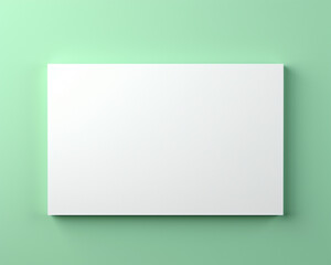 Fototapeta premium Blank white rectangular canvas on a pastel green wall, ideal for custom artwork, graphic design, presentations, or advertising mockups.