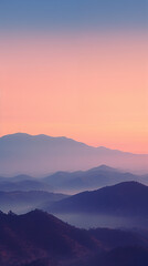 Obraz premium Serene mountain landscape at sunset with layers of mountains fading into the horizon under a colorful sky.