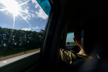mature woman travels by car on the roads of Altai with mountains flashing outside the window