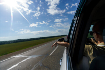 mature woman travels by car on the roads of Altai with mountains flashing outside the window