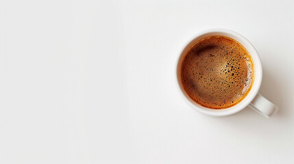 Fresh coffee in white cup on white background. Aromatic fresh coffee in a white cup on a white background, top view, with copy space.