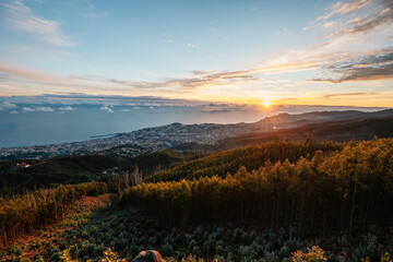 beautiful sunset over the city of Funchal on Madeira from the location Miradouro do Pico Alto....